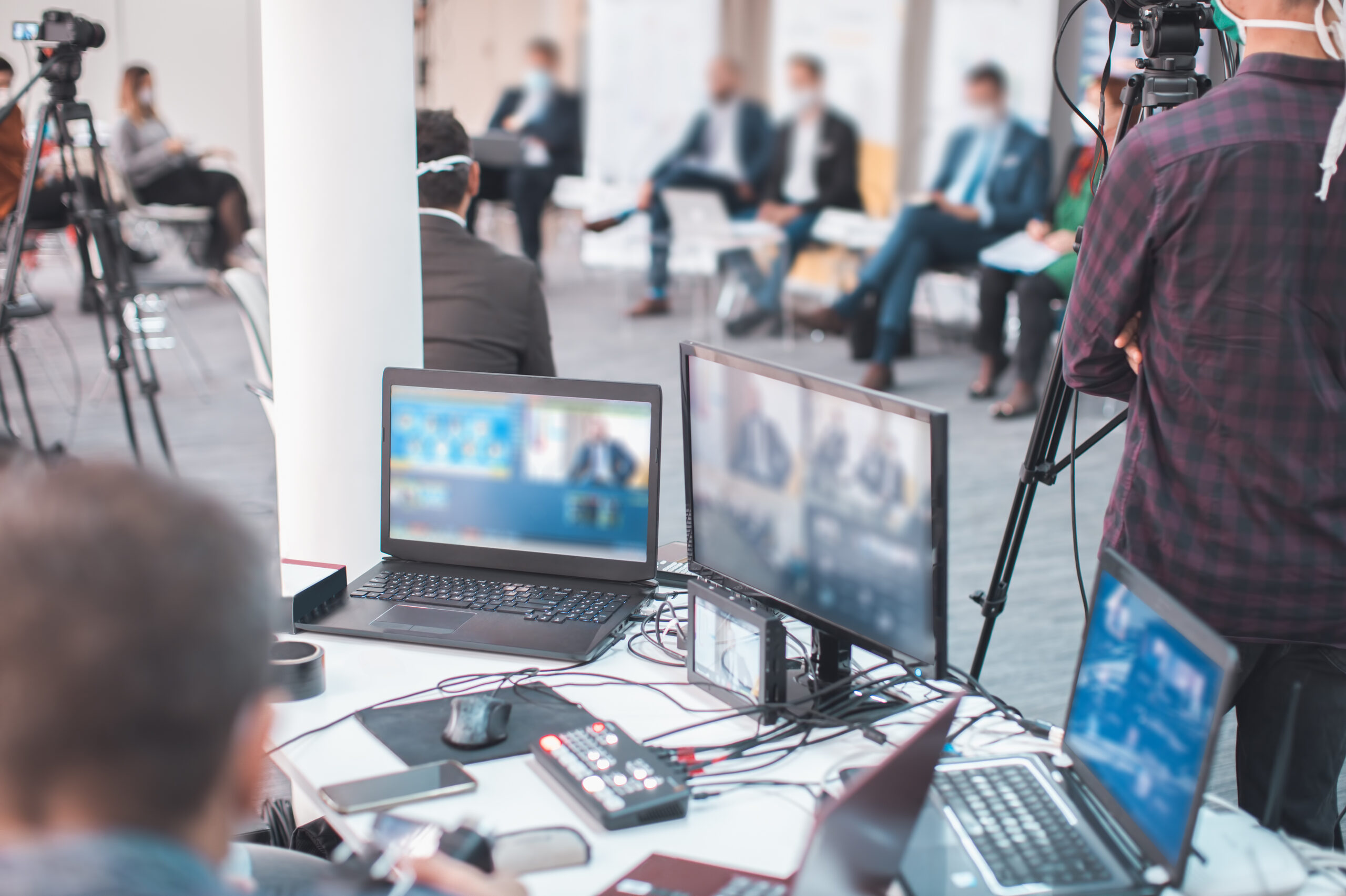 A set of computers and cameras at a corporate event